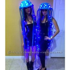 two women dressed up as jellyfishs with blue lights on their heads and legs