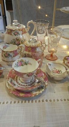 a table topped with lots of fancy china