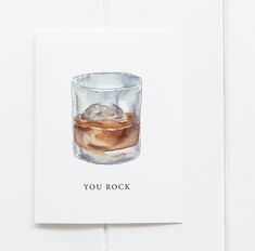 there is a card with an image of a glass of whiskey and ice on it