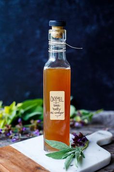 a bottle filled with liquid sitting on top of a cutting board