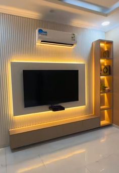 a modern living room with an entertainment center and built - in shelving unit for the tv