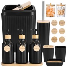 black and gold bathroom accessories including soap dispenser, toothbrush holder, tumbler with bamboo lid