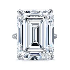 an emerald - cut diamond ring with three diamonds on each side and two clawed shoulders