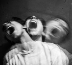 black and white photograph of two people screaming