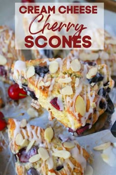 a white plate topped with blueberry cream cheese scones