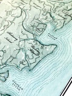 a close up of a map with water and land in the foreground on a white background