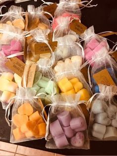 small bags filled with different colored marshmallows on top of a tiled floor