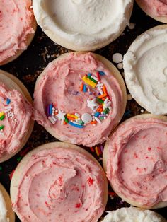 several cupcakes with pink frosting and sprinkles on the top