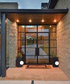 an entrance to a home with glass doors