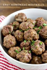 a white bowl filled with meatballs on top of a red and white checkered table cloth