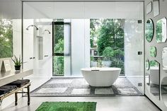 a bathroom with a large white bathtub sitting next to a walk in shower