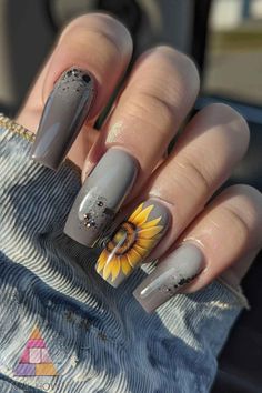 Add a touch of elegance to your nails with these sophisticated sunflower nail art designs on a chic grey base. Perfect for any occasion, these sunflower nails combine style and grace effortlessly. For more sunflower nail ideas, visit nailhow.com. #SunflowerNailsDesign #SunflowerNailArt #SpringNails #NailIdeas Sunflower Nail Designs, Lemon Nails, Silk Wrap Nails, Brown Nails Design, Boho Nails