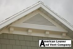 an american louver and vent company logo on the side of a house with clouds in the background