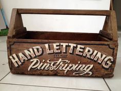 an old wooden sign that says hand lettering pilstriping on the front and side