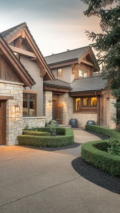 a large house with hedges in front of it and a driveway leading to the front door