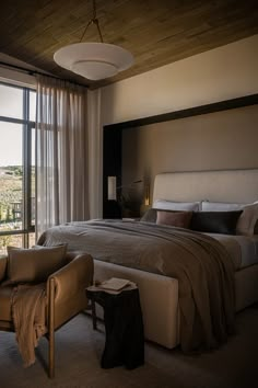 a large bed sitting next to a window in a bedroom