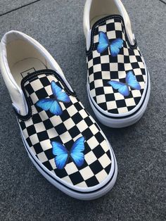 Custom Sneaker Vans Slip Ons ButterflyThe custom features 2 blue butterflies on top of each shoe.Each pair is handmade so the actual shoe might differ slighty to the one on the picture.All customs are 100% scratch and water resistant and fully wear- and cleanable. Message me if you want to change anything about it, I can almost fully change it to whatever you like!Note that everything is handmade, so you can expect at least 1 week for the painting process + shipping time for it to arrive at your Custom Sneakers Vans, Shoe Customization, Sneaker Vans, Vans Shoes Fashion, Vans Slip Ons, Vans Shoes Women