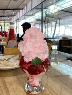 a dessert sundae with strawberries and whipped cream