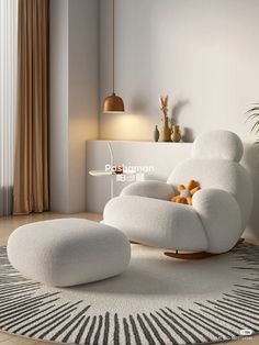 a white chair and ottoman in a living room with a rug on the floor next to it