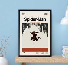 a spider - man movie poster is displayed on a shelf next to a vase and lamp