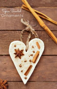 an ornament shaped like a heart with cinnamons and star anise on it