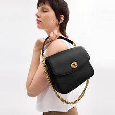 A more compact Cassie our 19 is smaller than the original and made for days or nights on the go. The polished pebble leather design is finished with a Signature turnlock closure and three interchangeable straps for versatile styling. Detach the crossbody strap and carry by hand with the leather and chain top handles together or separately. | Coach Cassie Crossbody Bag 19 - Women's Designer Crossbody - Brass/black Coach Pebbled Leather Shoulder Bag With Detachable Strap, Coach Pebbled Leather Bag With Adjustable Strap, Coach Pebbled Leather Satchel With Detachable Strap, Versatile Coach Bag With Detachable Strap, Top Handle Pebbled Leather Shoulder Bag With Branded Hardware, Workwear Crossbody Flap Bag With Fold Over Clasp, Everyday Satchel With Branded Hardware In Pebbled Leather, Everyday Flap Shoulder Bag With Branded Hardware, Everyday Satchel Flap Bag With Branded Hardware