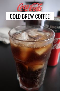 a cold drink with ice and coke on the table