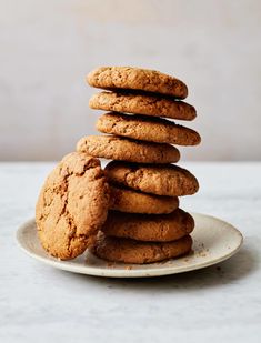 a stack of cookies sitting on top of a white plate