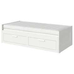 a white bed with two drawers on the bottom and one drawer open to show it's mattress