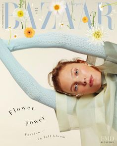 a woman is posing on the cover of bazaar magazine, with flowers in her hair