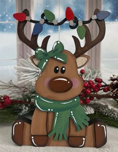 a wooden reindeer ornament with lights on it's antlers sitting in front of a window