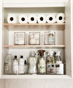 the shelves are filled with toiletries and hand soaps, including rolls of toilet paper