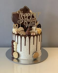 a birthday cake is decorated with chocolate, cookies and marshmallows