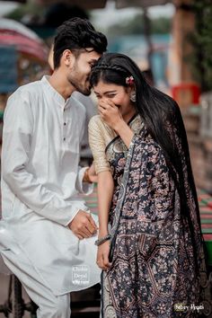 a man and woman standing next to each other