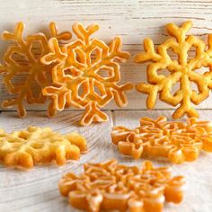 there are several different types of cookies on the table with snowflakes around them