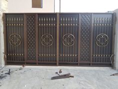 an iron gate with three circular designs on it