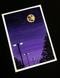 an image of a night scene with the moon in the sky and street lights lit up