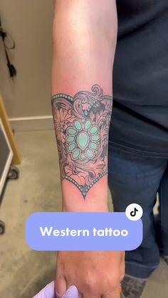 a person with a tattoo on their arm and the words western tattoo written below it