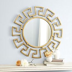 a mirror sitting on top of a white mantle