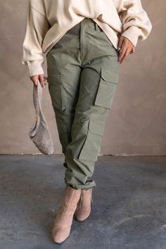 #html-body [data-pb-style=Q1VWAPJ]{justify-content:flex-start;display:flex;flex-direction:column;background-position:left top;background-size:cover;background-repeat:no-repeat;background-attachment:scroll} The Cleo Olive Parachute Cargo Pants feature olive green lightweight fabric with a matte finish, a front zipper with a button closure, belt loops, an elastic back band, two front slip pockets, four side cargo pockets, two back cargo pockets, stitched details, and relaxed legs with elastic ankles and adjustable bungees. Content & Care • 100% Polyester • Hand wash cold Size & Fit The model is 5'8" and wearing a small. Wide Leg Cargo Pants Outfit, Parachute Cargo Pants, Olive Green Cargo Pants, Parachute Cargo, Cargo Pants Outfit, Style Inspiration Casual, Green Cargo Pants, Top Background, Cover Background