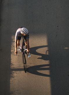 a man riding a bike down the middle of a street