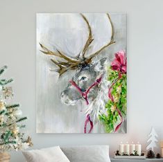 a living room decorated for christmas with a painting of a deer wearing a red scarf