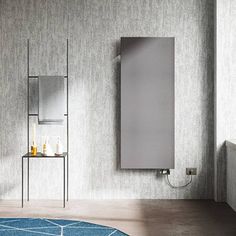 a bathroom with a blue rug, mirror and shelving unit on the wall next to it