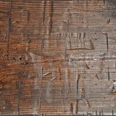 an old wooden table with peeling paint on the top and wood grains all over it