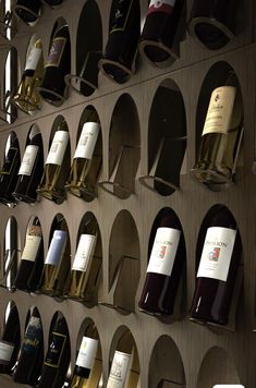 many bottles of wine are lined up on the wall