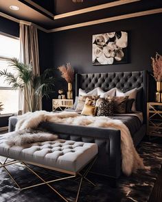 a bedroom with black walls, gold accents and fur on the footboard is shown