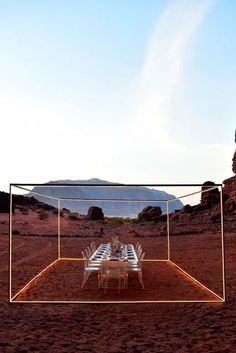 a dining table is set up in the desert