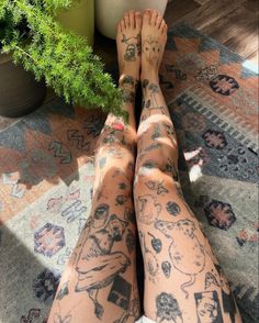 the legs and arms of a woman with tattoos