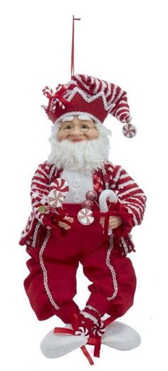 a red and white santa claus ornament hanging from a string on a white background