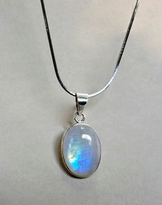 "This pendant necklace is made from 925 sterling silver and natural rainbow moonstone. Very beautiful and changing color according to a source of light! It looks fabulous and timeless :)  ♥ Please note as with all natural gemstones the color and inclusions may vary slightly from the pair shown. ♥ Each order will be gift wrapped beautifully ♥ QUALITY: Each item is stamped according to US regulations.  ➤ Orders of $550 and more will be qualified for free UPS International Express shipping (2-3 day Rainbow Moonstone Necklace, Rainbow Moonstone Pendant, Women Pendant, Blue Moonstone, Natural Rainbow, Moonstone Necklace, Moonstone Jewelry, Moonstone Pendant, 925 Sterling Silver Chain